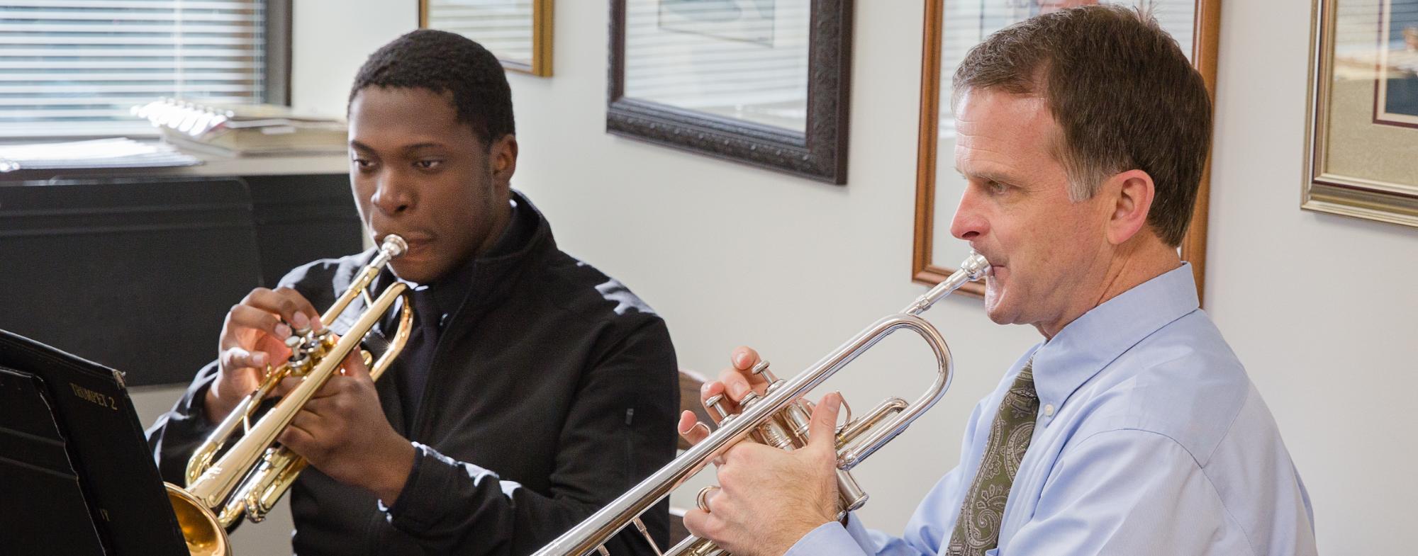 A student has a trumpet lesson with Dr. Bruce Cox